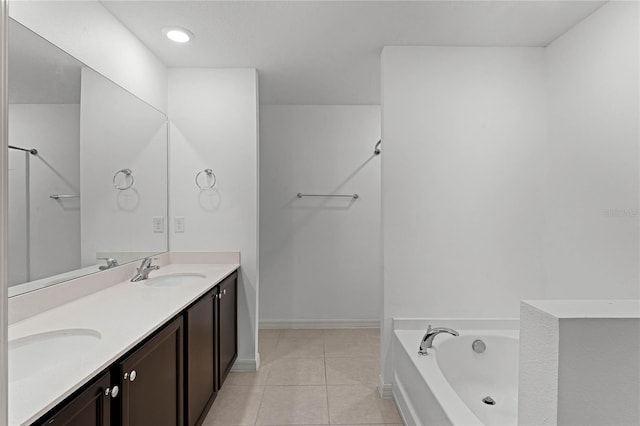 bathroom with vanity, tile patterned floors, and a bathing tub