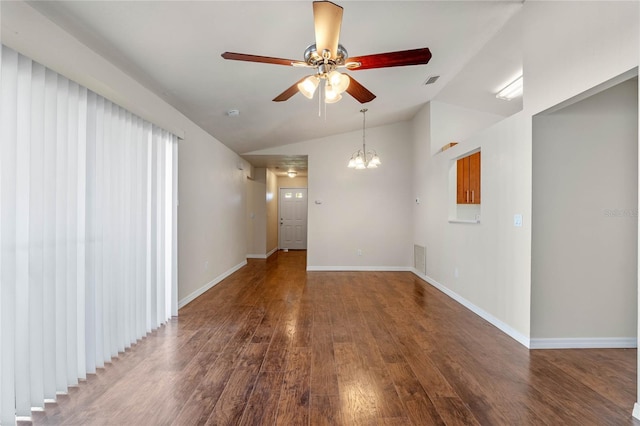 empty room featuring ceiling fan with notable chandelier, dark hardwood / wood-style flooring, and lofted ceiling