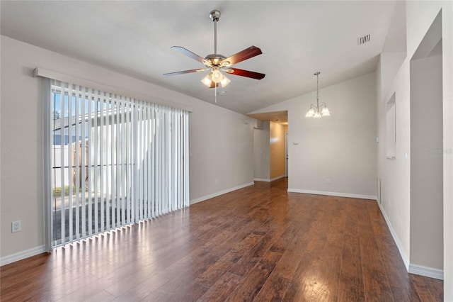 empty room with ceiling fan with notable chandelier, dark wood-type flooring, and vaulted ceiling