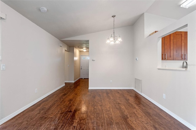 unfurnished dining area featuring lofted ceiling, sink, a notable chandelier, and dark hardwood / wood-style flooring