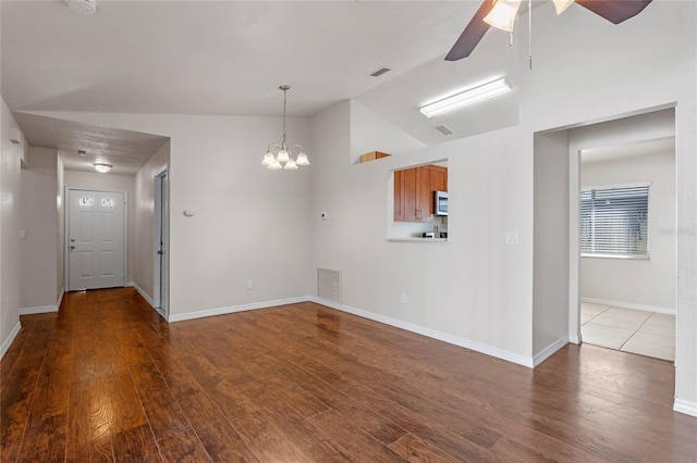 interior space with ceiling fan with notable chandelier, hardwood / wood-style floors, and lofted ceiling