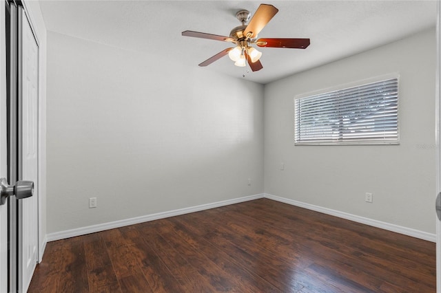 empty room with ceiling fan and dark wood-type flooring