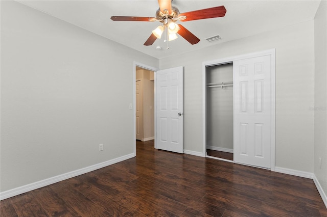 unfurnished bedroom featuring dark wood-type flooring, ceiling fan, and a closet