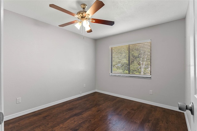 unfurnished room with ceiling fan and dark hardwood / wood-style flooring