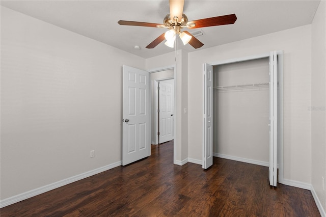 unfurnished bedroom featuring ceiling fan, dark hardwood / wood-style flooring, and a closet