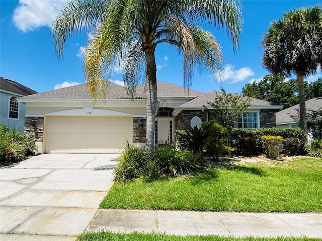 view of front facade featuring a front yard and a garage