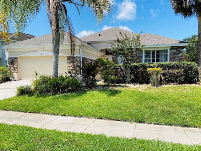 view of front of home with a garage and a front lawn