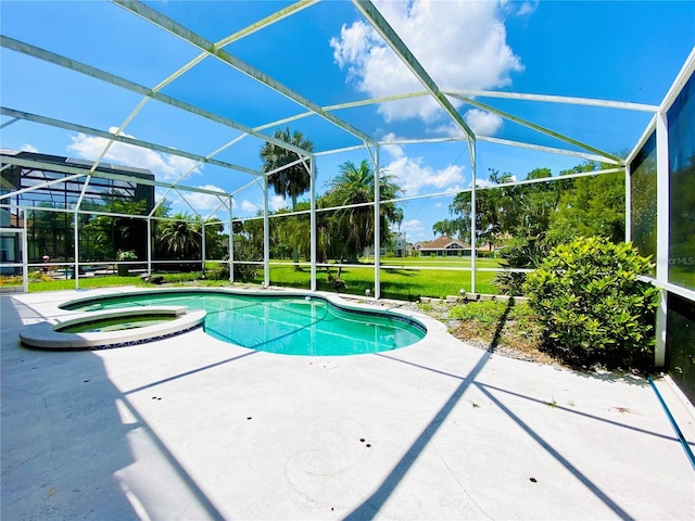 view of swimming pool with an in ground hot tub, a patio, and a lanai