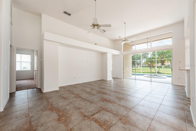 spare room featuring ceiling fan and a high ceiling