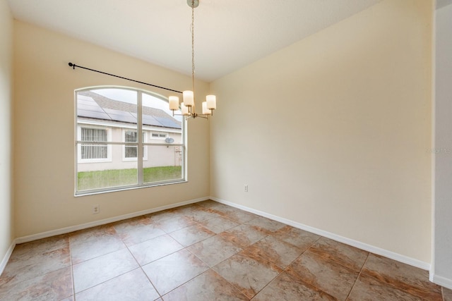 empty room featuring a notable chandelier