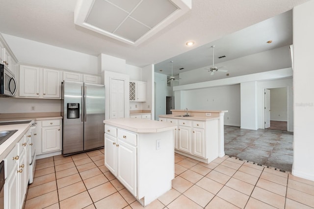 kitchen featuring a center island, white cabinets, and stainless steel appliances