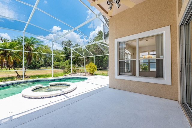 view of pool with a lanai, a patio area, and an in ground hot tub