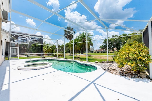 view of pool featuring an in ground hot tub, a patio, and glass enclosure