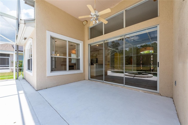 view of patio with a lanai and ceiling fan