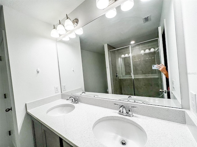 bathroom featuring vanity and an enclosed shower