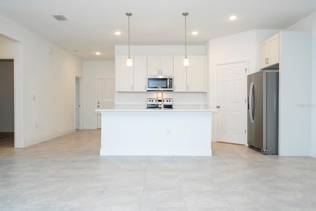 kitchen with white cabinets, pendant lighting, an island with sink, and appliances with stainless steel finishes