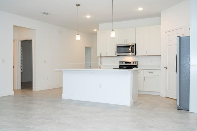 kitchen featuring a center island with sink, white cabinets, and stainless steel appliances