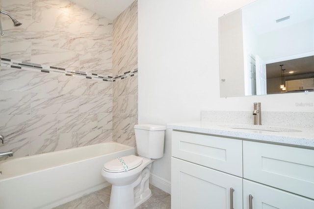 full bathroom with tile patterned flooring, toilet, vanity, and tiled shower / bath