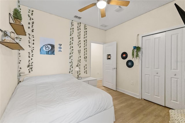 bedroom featuring ceiling fan, a closet, and light hardwood / wood-style flooring