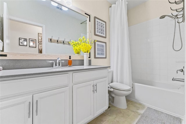 full bathroom with tile patterned floors, shower / bath combo with shower curtain, vanity, and toilet