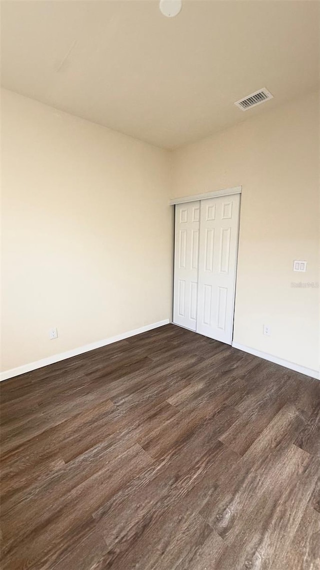 322 N 6th St, Haines City, FL 33844 - unfurnished bedroom featuring dark wood-style flooring and a closet