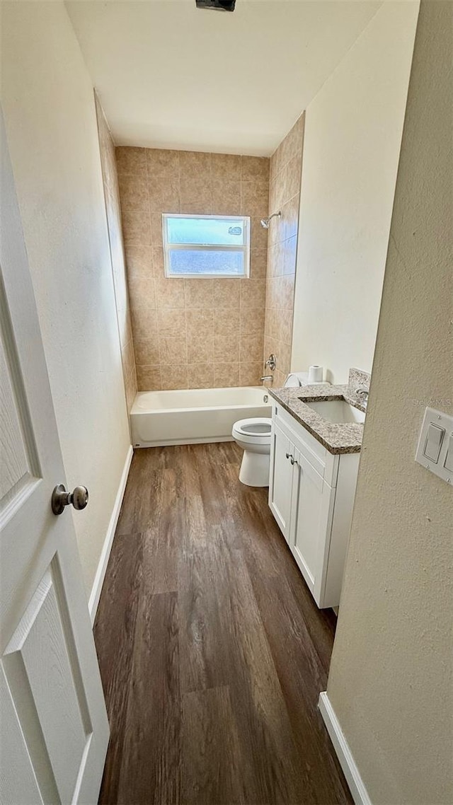 322 N 6th St, Haines City, FL 33844 - bathroom featuring vanity, wood finished floors, shower / washtub combination, and a textured wall