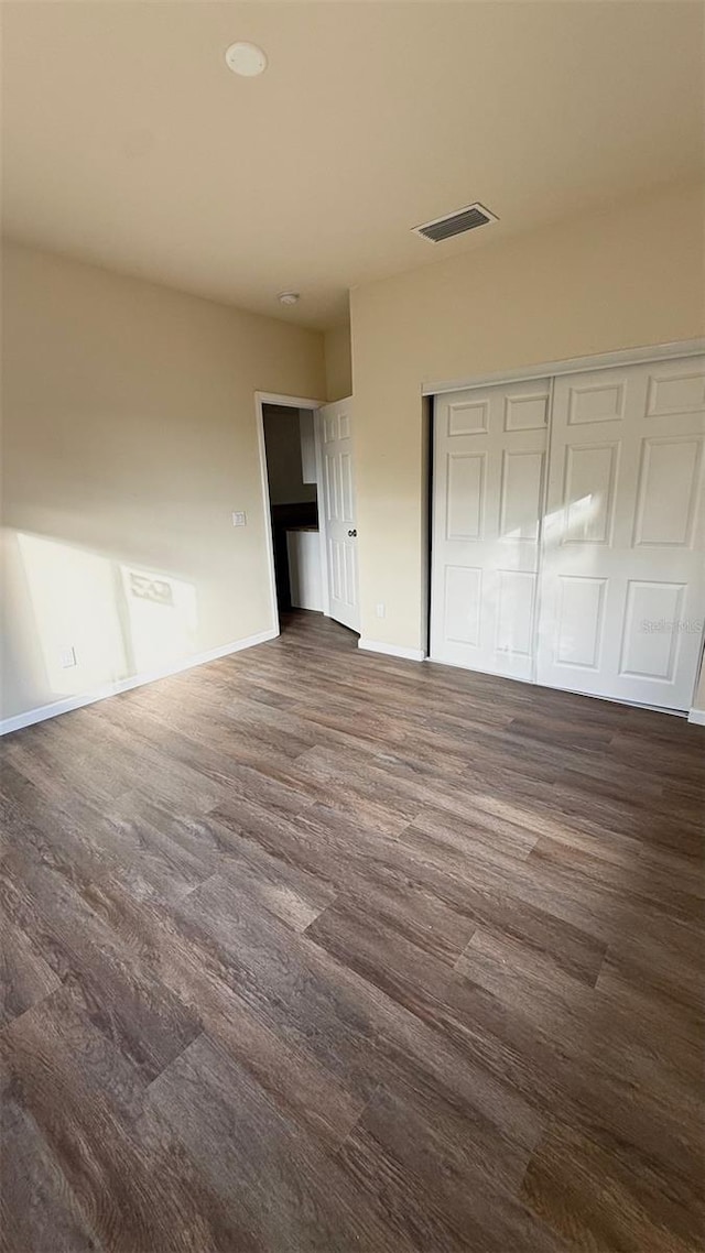 322 N 6th St, Haines City, FL 33844 - unfurnished bedroom with dark wood-style floors and a closet