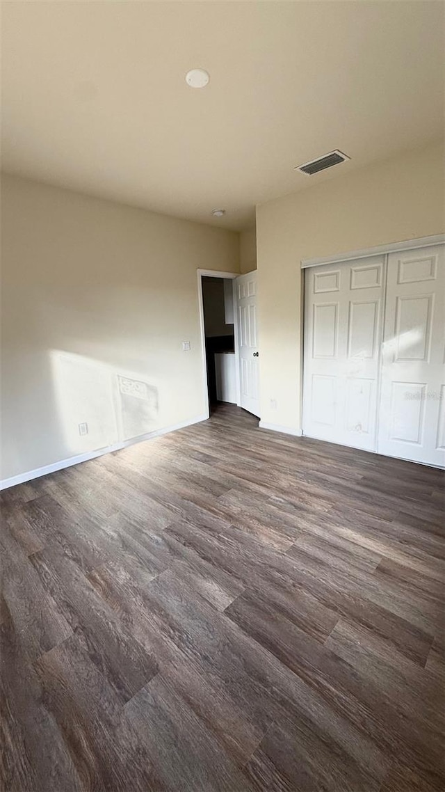 322 N 6th St, Haines City, FL 33844 - unfurnished bedroom featuring dark wood-style flooring and a closet