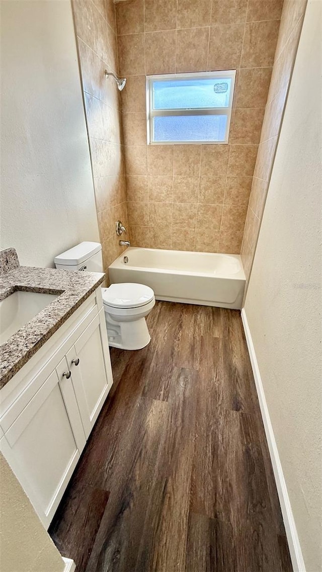 322 N 6th St, Haines City, FL 33844 - full bath with wood finished floors, vanity, and shower / tub combination