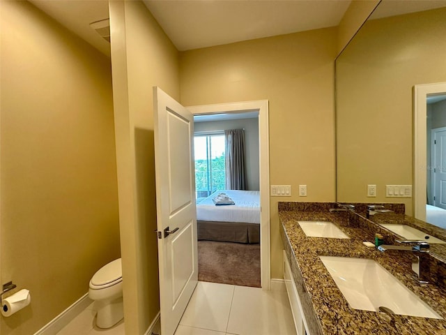 bathroom featuring tile patterned flooring, vanity, and toilet