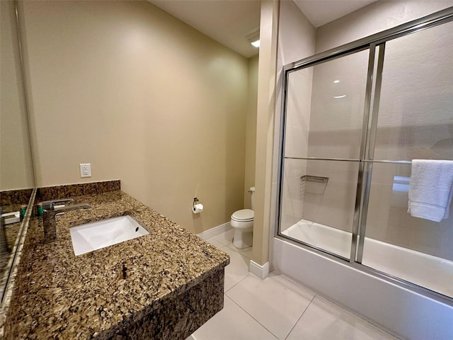 full bathroom with tile patterned flooring, vanity, toilet, and bath / shower combo with glass door