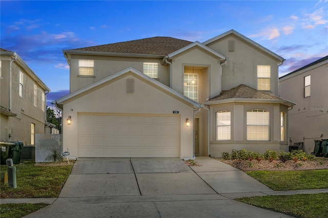 128 Higher Combe Dr, Davenport, FL 33897 - traditional-style house with stucco siding, concrete driveway, and a garage