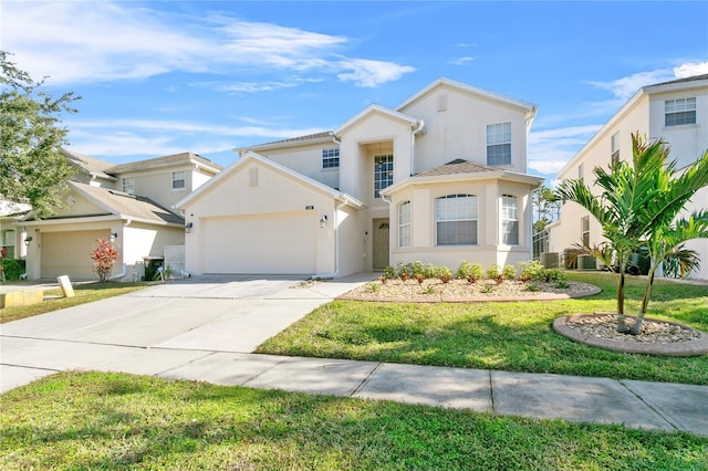 view of front of property with a front yard and a garage