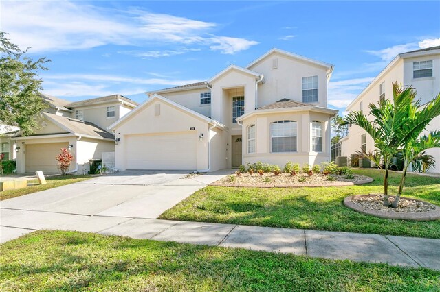 128 Higher Combe Dr, Davenport, FL 33897 - traditional home with stucco siding, driveway, an attached garage, and a front lawn