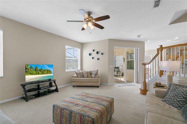 carpeted living room with ceiling fan