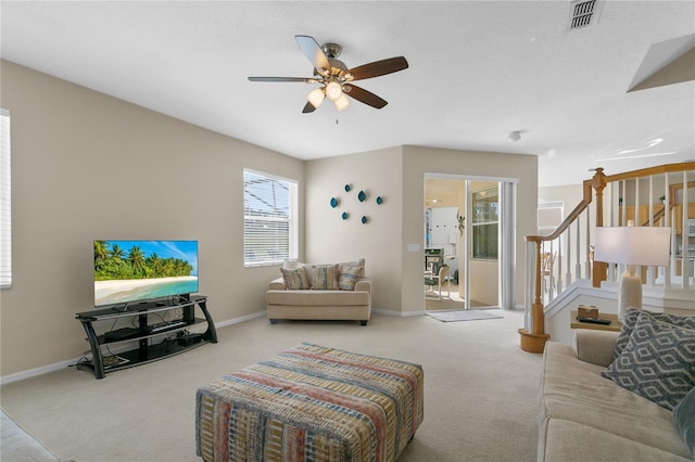 128 Higher Combe Dr, Davenport, FL 33897 - living area featuring carpet floors, a ceiling fan, and stairway