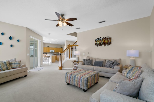 living room with ceiling fan and light carpet