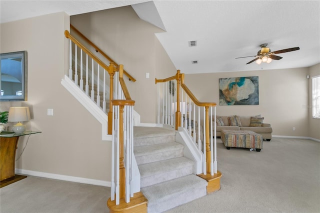 stairs with carpet and ceiling fan