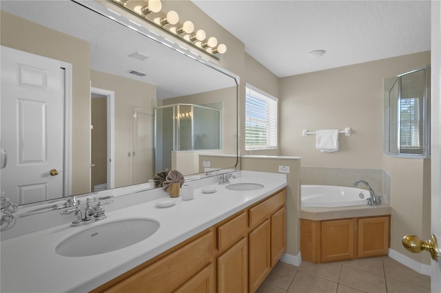 full bathroom with vanity, plus walk in shower, tile patterned floors, toilet, and a textured ceiling