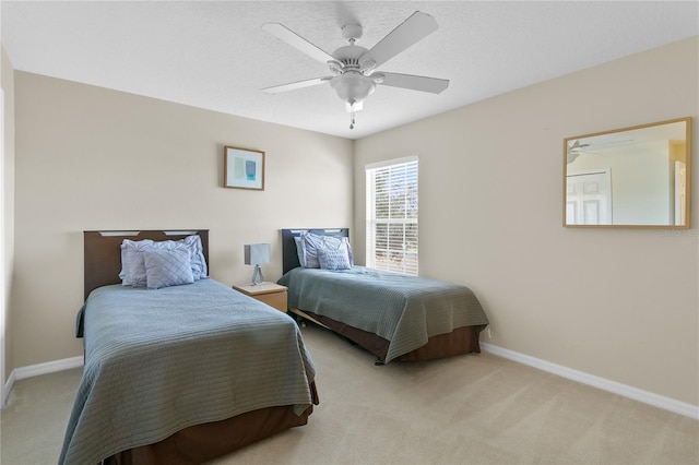 bedroom with ceiling fan and light carpet