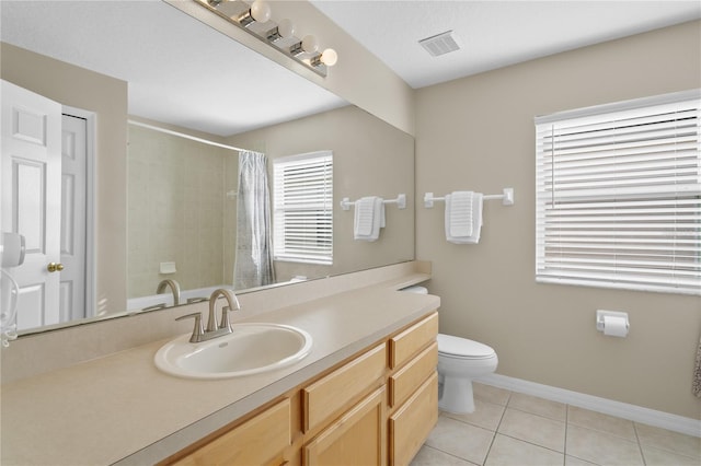 bathroom featuring tile patterned floors, a shower with curtain, vanity, and toilet