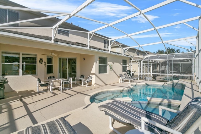 view of pool with ceiling fan, a patio area, and glass enclosure