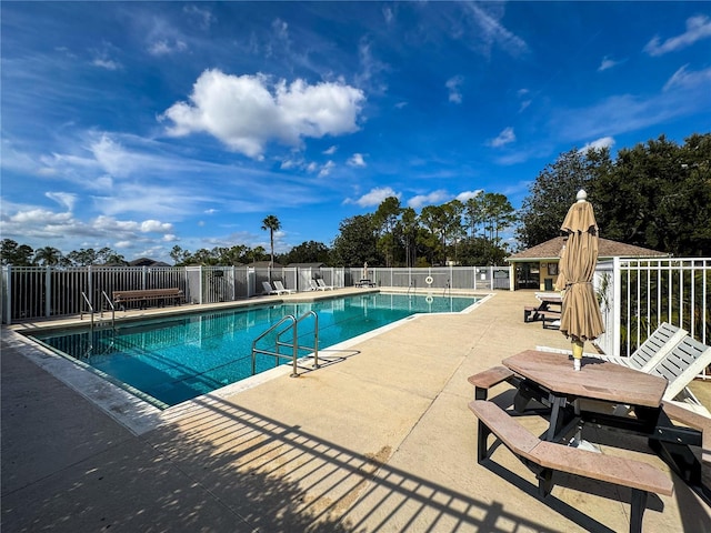 view of swimming pool featuring a patio area