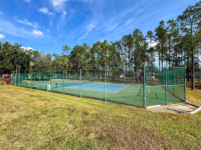 view of sport court featuring a lawn