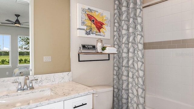 full bathroom with ceiling fan, vanity, shower / bath combo, and toilet