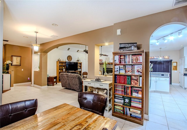 interior space with ceiling fan