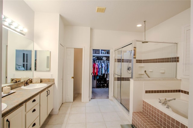 bathroom featuring plus walk in shower, tile patterned floors, and vanity