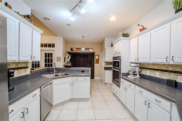 kitchen featuring backsplash, sink, stainless steel appliances, and white cabinetry