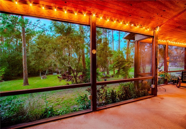 unfurnished sunroom with wooden ceiling