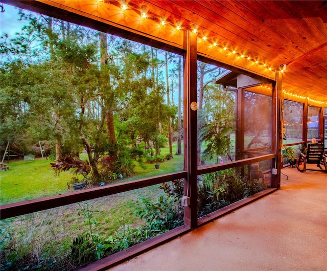 unfurnished sunroom featuring wooden ceiling